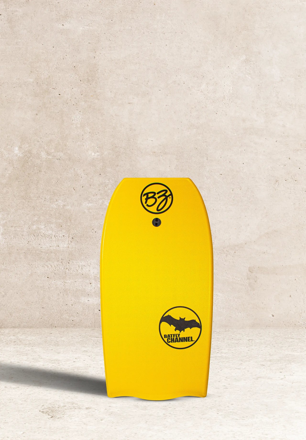 Smiling surfer riding a wave on a yellow BZ Pro Boards bodyboard in the ocean