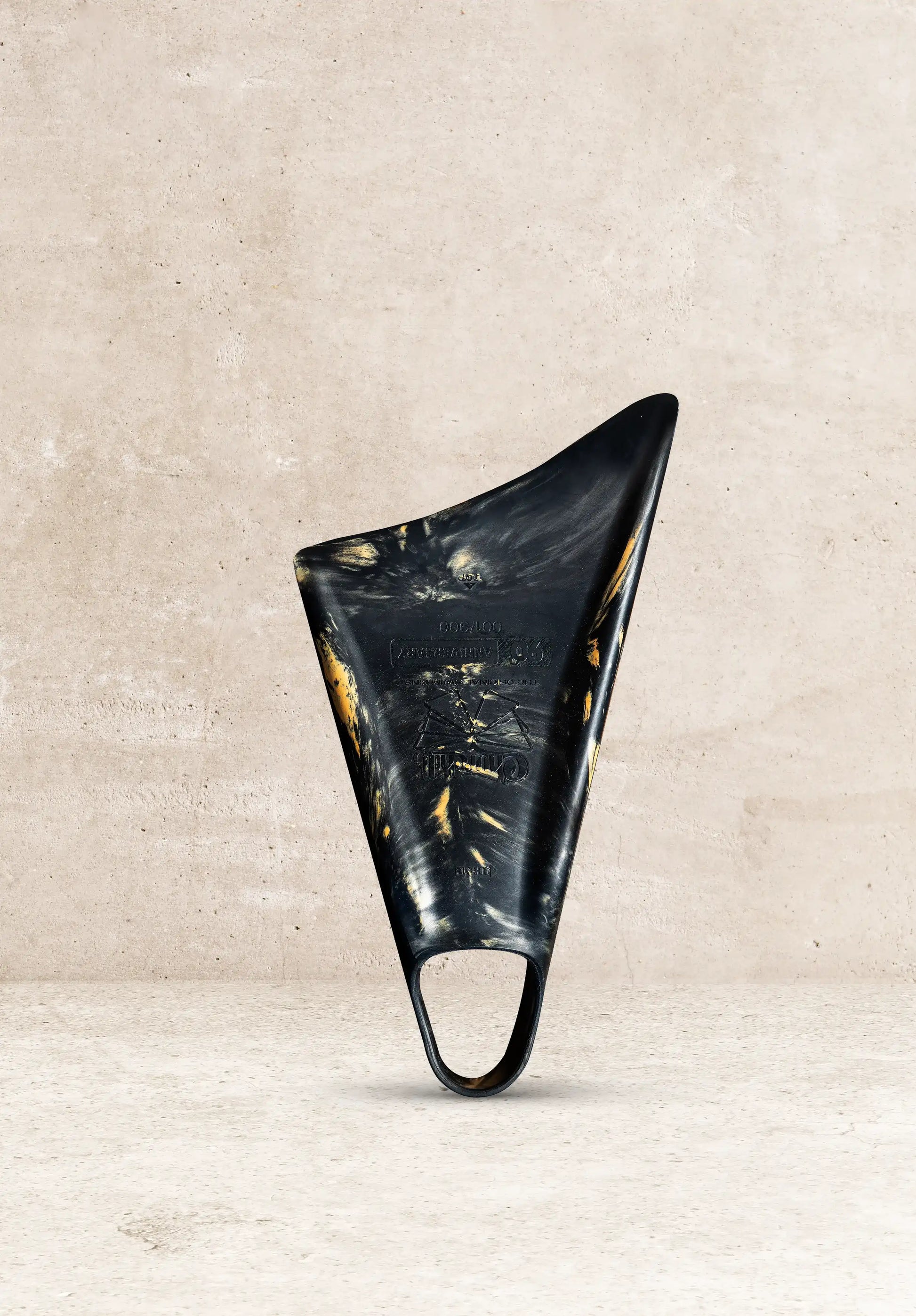 Black and gold limited edition boogie board with 50th anniversary design, displayed against concrete background
